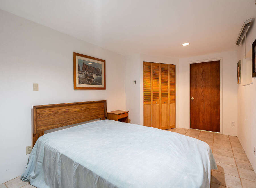This cozy bedroom features a comfortable bed with a light blue cover, perfect for a relaxing night's sleep.