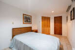 This cozy bedroom features a comfortable bed with a light blue cover, perfect for a relaxing night's sleep.