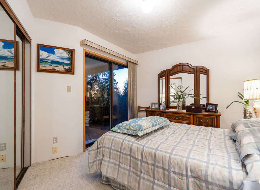 This inviting bedroom boasts a comfortable bed with a stylish comforter, perfect for relaxation.