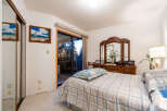 This inviting bedroom boasts a comfortable bed with a stylish comforter, perfect for relaxation.