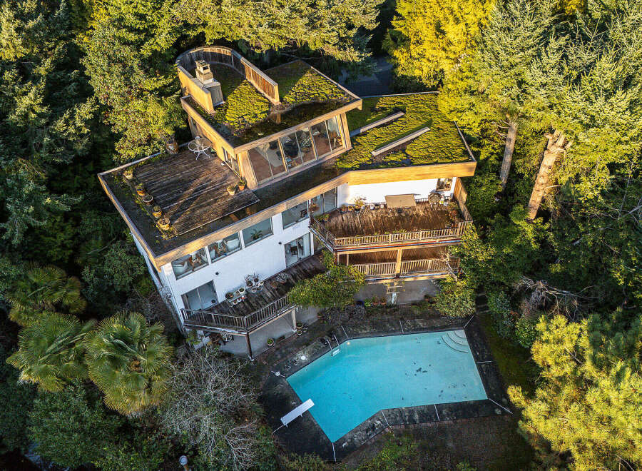 This stunning property boasts a unique architectural design, seamlessly blending with its lush, natural surroundings.