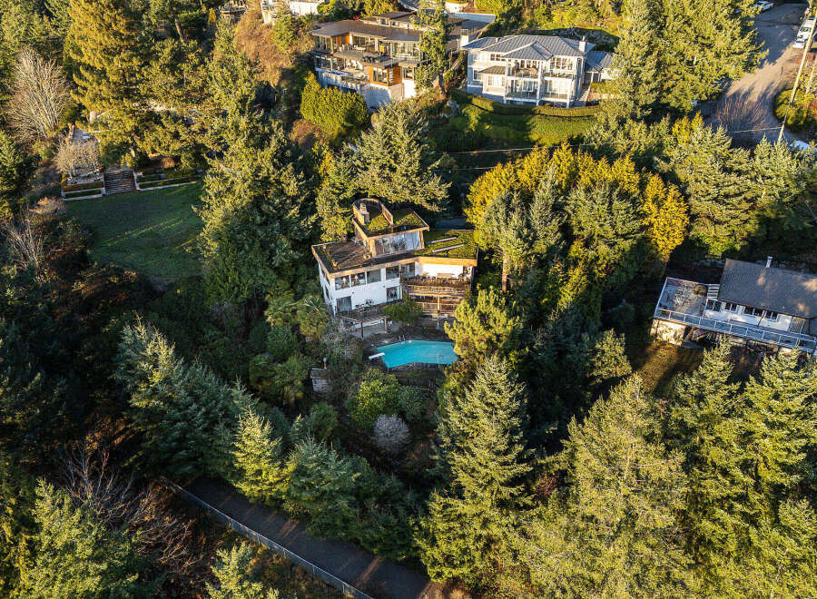Nestled amidst lush greenery, this stunning property boasts a luxurious swimming pool, perfect for relaxation and entertainment.