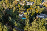 Nestled amidst lush greenery, this stunning property boasts a luxurious swimming pool, perfect for relaxation and entertainment.