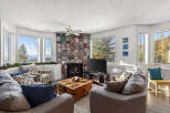 This stunning living room boasts a cozy fireplace and ample natural light, perfect for relaxing or entertaining.