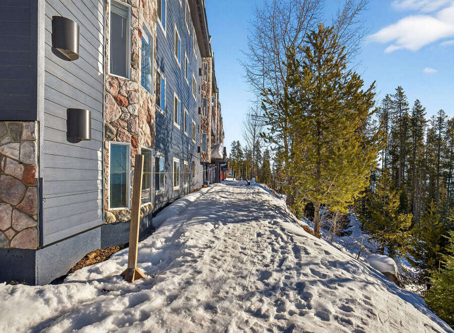 Discover a stunning property nestled in a serene, snow-covered landscape.