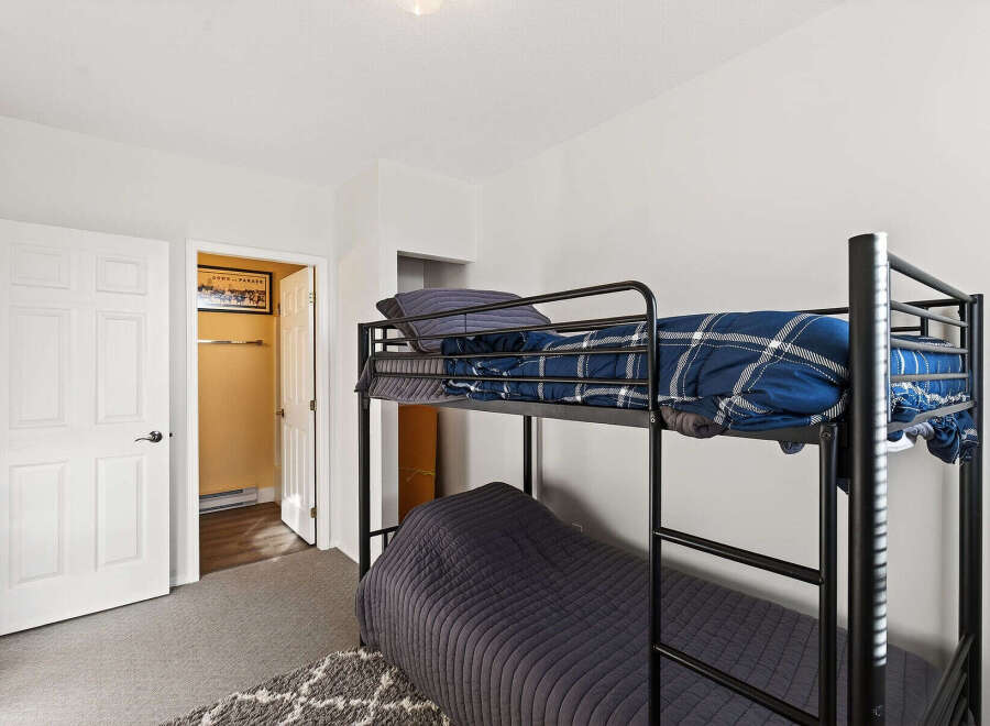 This cozy bedroom features a bunk bed, perfect for maximizing space.