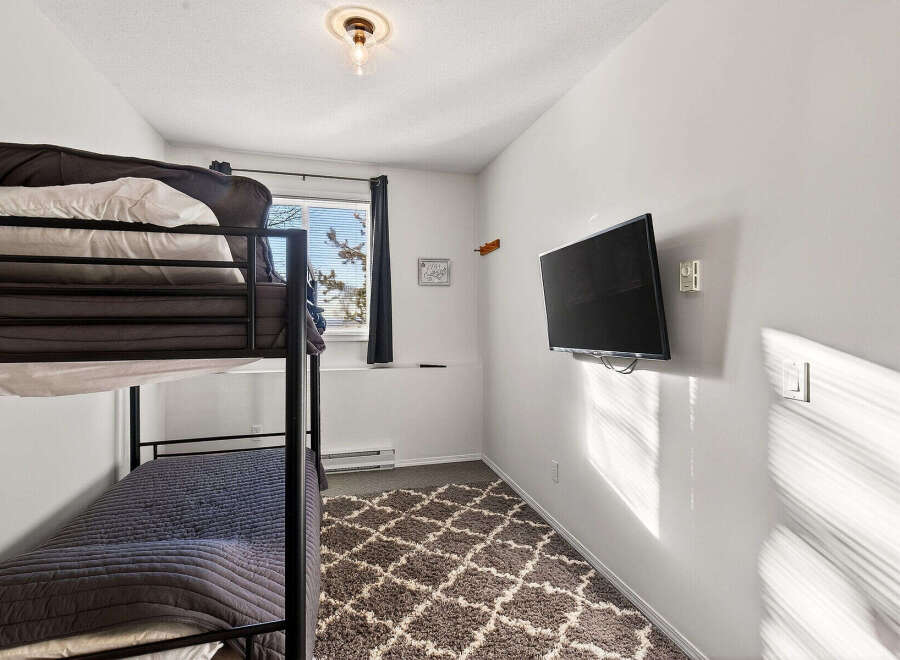 Cozy bedroom featuring a bunk bed, perfect for accommodating guests or family members.