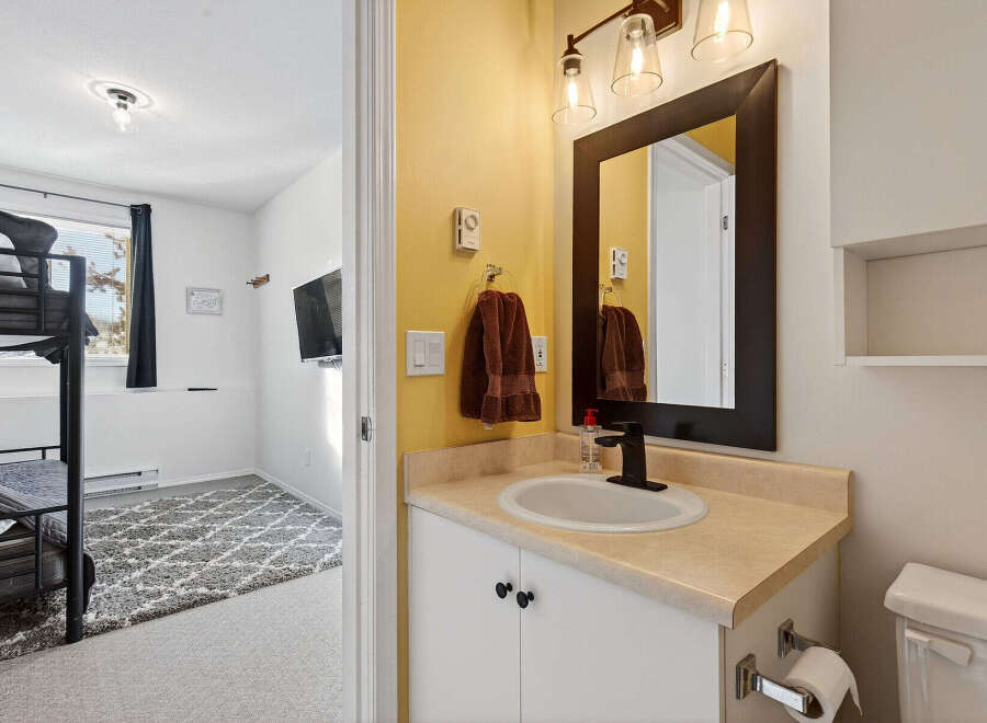 Discover this charming property featuring a well-appointed bathroom with a stylish vanity and a modern sink.