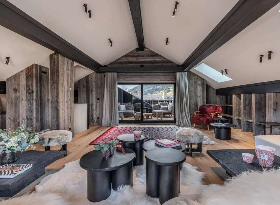 Experience luxury living in this stunning property, featuring a beautifully designed living room with rustic wooden accents and a cozy ambiance.