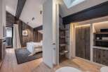 This stunning bedroom boasts a rustic charm with its wooden paneling and exposed beams, creating a warm and inviting atmosphere.