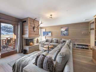 Experience the epitome of luxury living in this stunning chalet, boasting a cozy fireplace and a spacious, inviting living area.