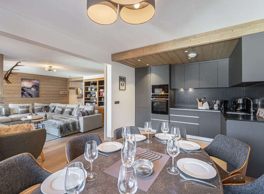 Experience luxury living in this stunning property, featuring a modern kitchen and a spacious dining area perfect for entertaining.