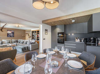 Experience luxury living in this stunning property, featuring a modern kitchen and a spacious dining area perfect for entertaining.