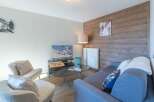 This cozy living space offers a perfect blend of comfort and style, ideal for relaxation after a day on the slopes.