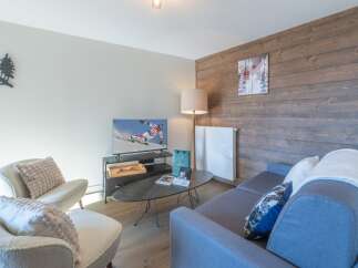 This cozy living space offers a perfect blend of comfort and style, ideal for relaxation after a day on the slopes.