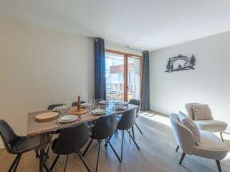 Experience luxury living in this stunning property, featuring a spacious dining area perfect for entertaining.