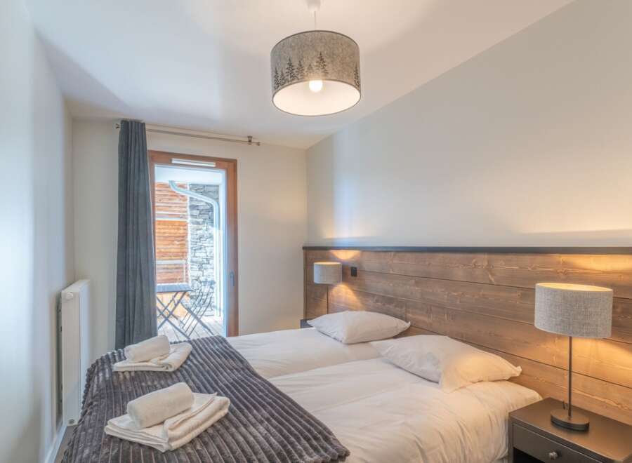 This cozy bedroom offers a serene retreat with its inviting ambiance and stylish decor.