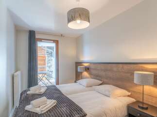 This cozy bedroom offers a serene retreat with its inviting ambiance and stylish decor.