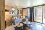 This cozy living space features a stylish gray sectional sofa, perfect for relaxing after a day on the slopes.