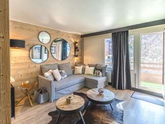 This cozy living space features a stylish gray sectional sofa, perfect for relaxing after a day on the slopes.