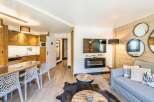 Discover the charm of this beautifully designed property, featuring a cozy living area with a modern fireplace and a stylish dining space.