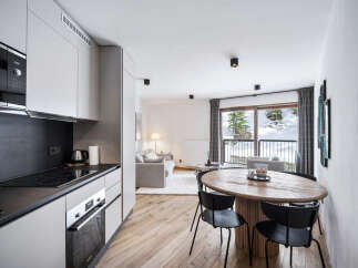 Experience modern living in this stylish apartment, featuring a sleek kitchen with contemporary appliances and ample counter space.
