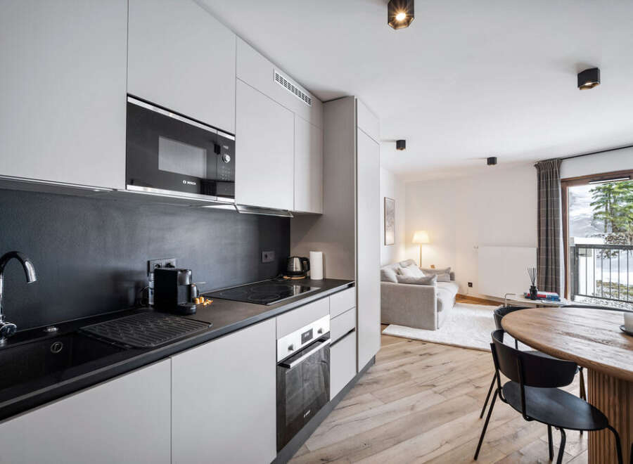Discover modern living in this stylish apartment featuring a sleek kitchen with stainless steel appliances and ample storage.