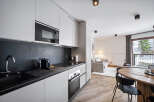 Discover modern living in this stylish apartment featuring a sleek kitchen with stainless steel appliances and ample storage.