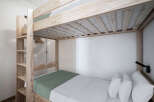 This cozy bedroom features a stylish bunk bed, perfect for maximizing space.