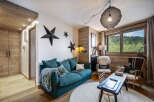 This cozy living room features a stylish teal sofa, perfect for relaxing after a long day.