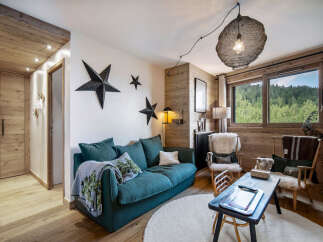This cozy living room features a stylish teal sofa, perfect for relaxing after a long day.