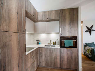 This stunning kitchen boasts custom wood cabinetry, offering both style and ample storage space.