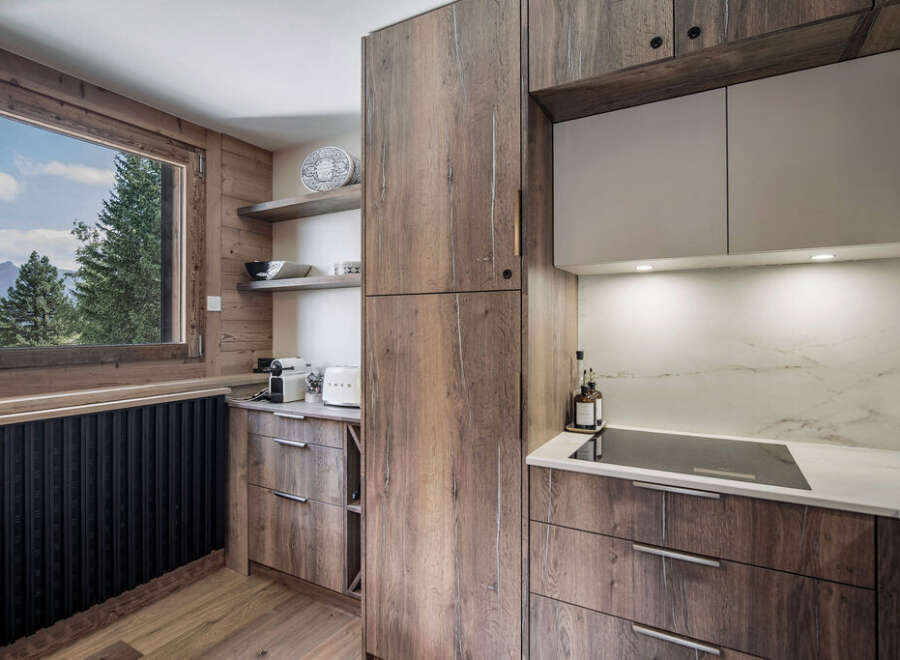 This stunning kitchen boasts a modern design with rustic wood cabinetry, creating a warm and inviting atmosphere.