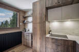 This stunning kitchen boasts a modern design with rustic wood cabinetry, creating a warm and inviting atmosphere.