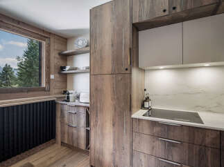 This stunning kitchen boasts a modern design with rustic wood cabinetry, creating a warm and inviting atmosphere.