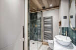 Step into luxury with this stunning bathroom featuring a modern shower and elegant fixtures.