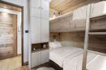 This cozy bedroom features a unique bunk bed design, perfect for maximizing space.