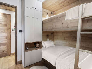 This cozy bedroom features a unique bunk bed design, perfect for maximizing space.