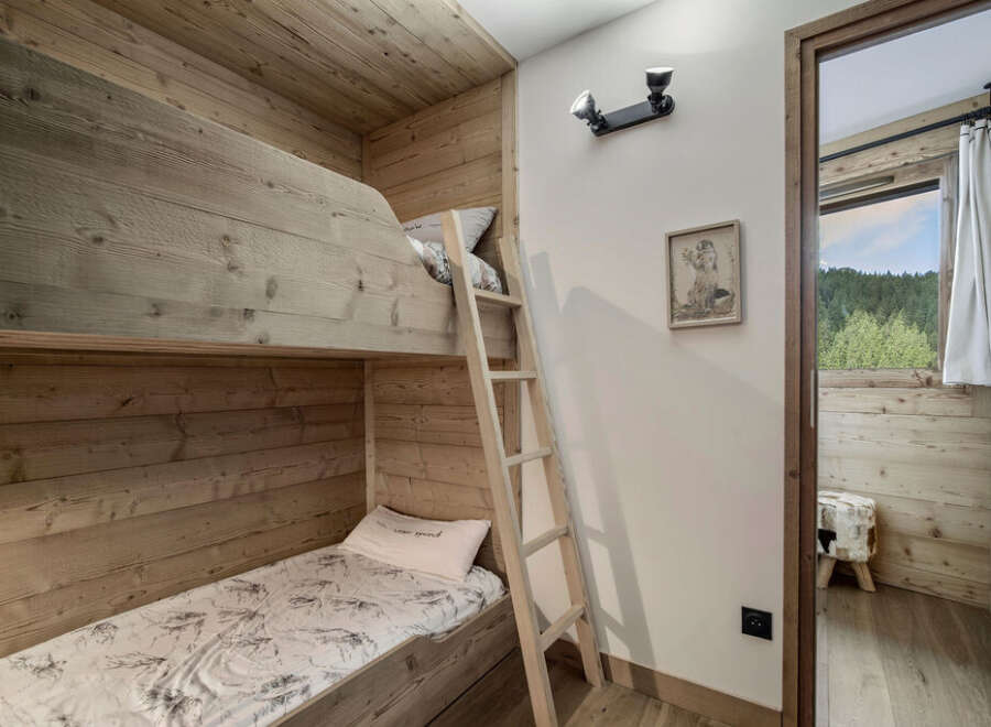 Discover the charm of this cozy bedroom featuring custom-built bunk beds, perfect for a family getaway.
