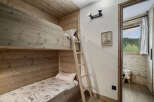 Discover the charm of this cozy bedroom featuring custom-built bunk beds, perfect for a family getaway.