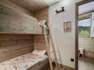 Discover the charm of this cozy bedroom featuring custom-built bunk beds, perfect for a family getaway.