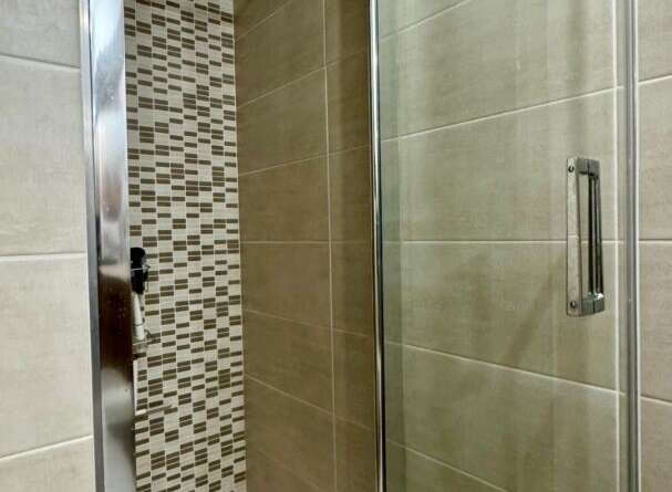 Step into a modern bathroom oasis with this stunning shower enclosure.