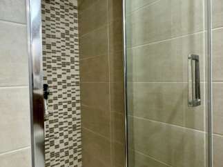 Step into a modern bathroom oasis with this stunning shower enclosure.