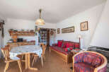 This charming property features a cozy living space with a dining area and a comfortable seating arrangement.