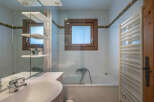 This charming bathroom features a bright and airy design, perfect for relaxation.