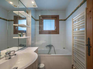 This charming bathroom features a bright and airy design, perfect for relaxation.