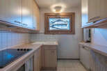 This charming kitchen features light wood cabinetry, offering a warm and inviting atmosphere.
