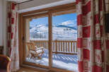 Enjoy breathtaking mountain views from this cozy property! This charming space features a balcony overlooking a snow-covered landscape, perfect for enjoying the winter season.