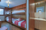This cozy bedroom features a unique bunk bed setup, perfect for families or groups.