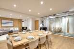 Experience luxury living in this stunning property, featuring a spacious dining area perfect for entertaining.